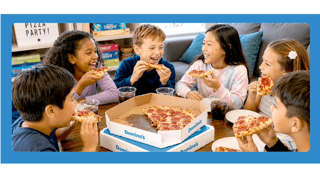 Kids enjoying Domino's pizza during a fundraiser